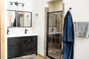 Full bathroom with dual shower heads and dual vanity which is in the main floor bedroom
