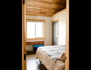 Guest bedroom #2  featuring wood finished floors and wooden ceiling