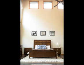 Bedroom featuring wood finished floors and baseboards