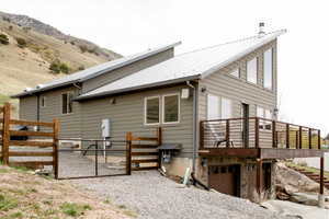 Looking south from the North , view of property with an attached garage, fence, and metal roof,, This are could be parking for a trailer, etc.
