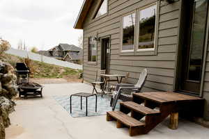View of patio / terrace with fence and a fire pit back yard.