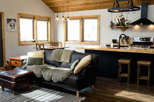 Living area with lofted ceiling, wooden ceiling, and dark wood finished floors