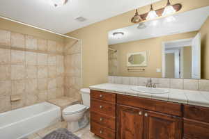 Bathroom featuring visible vents, tile patterned floors, vanity, and toilet