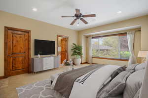 Master Bedroom in main floor with recessed lighting, ceiling fan, baseboards, and light carpet