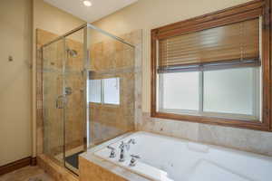 Master bathroom free standing shower with a jetted tub.