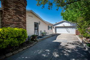 View of side of home with a garage and an outbuilding