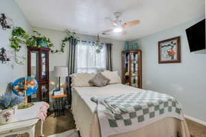 Bedroom with carpet floors, a ceiling fan, visible vents, and baseboards