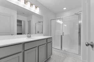 Full bath featuring a shower stall, a walk in closet, vanity, marble finish floor, and visible vents