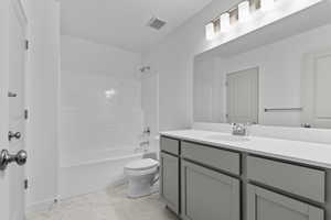 Bathroom with vanity, marble finish floor, toilet, shower / bathtub combination, and visible vents
