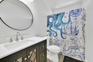 Full bathroom with curtained shower, wood finished floors, toilet, and vanity