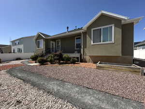 Ranch-style house featuring fence and stucco siding