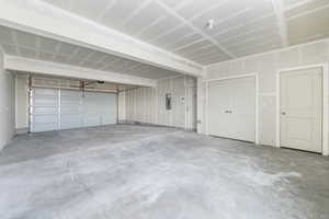 Garage featuring electric panel and a garage door opener