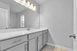 Bathroom with baseboards, vanity, and visible vents