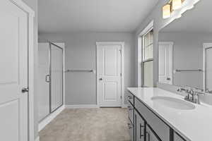 Bathroom featuring a shower stall and vanity