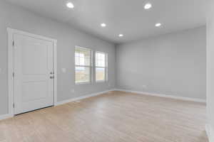 Spare room with recessed lighting, light wood-style floors, visible vents, and baseboards