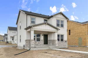 View of front of property with board and batten siding and stucco siding
