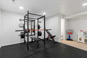 Workout area featuring baseboards, visible vents, and recessed lighting