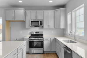 Kitchen featuring recessed lighting, a wealth of natural light, appliances with stainless steel finishes, and a sink