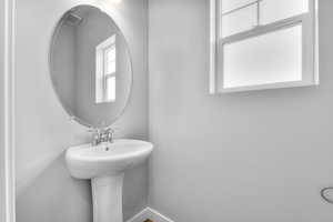 Bathroom with baseboards and a sink