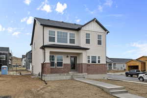 View of front of property with brick siding and stucco siding