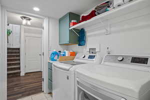 Clothes washing area featuring a textured ceiling, independent washer and dryer, light tile patterned floors, cabinet space, and recessed lighting