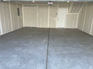 Garage with electric panel and a garage door opener