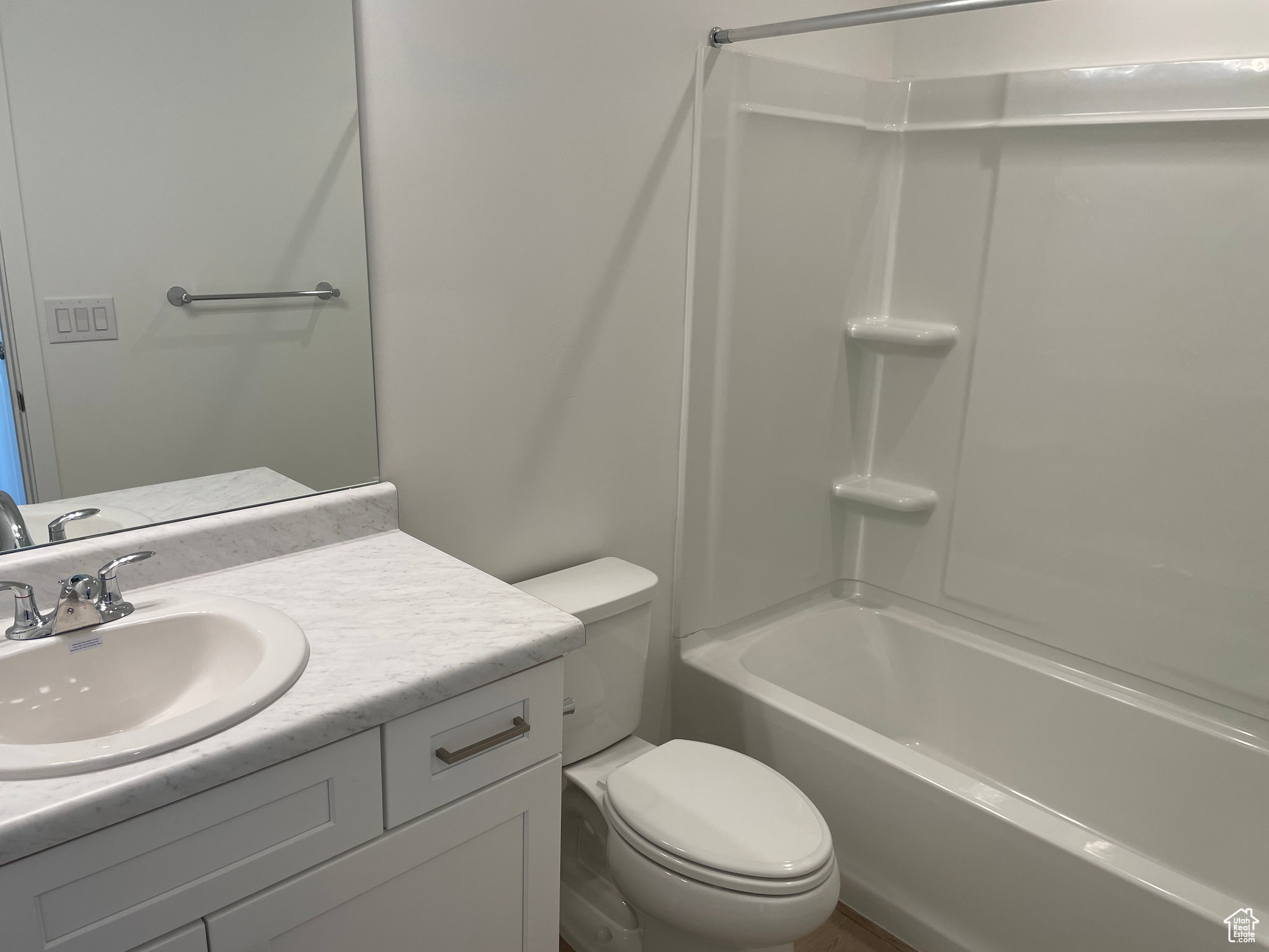 Full bathroom featuring toilet, vanity, and bathtub / shower combination