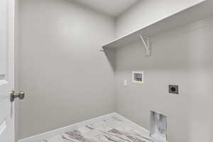 Laundry area featuring hookup for a washing machine, hookup for an electric dryer, marble finish floor, baseboards, and laundry area