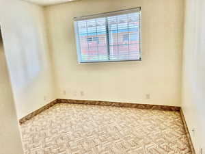 Carpeted spare room with healthy amount of natural light