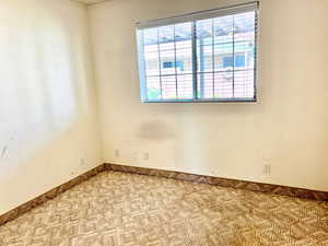 Unfurnished room featuring baseboards and carpet flooring