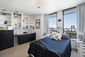 Bedroom featuring light carpet