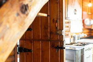 Interior details with white gas range and brown cabinets