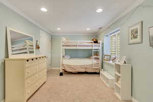 Bedroom with recessed lighting, visible vents, light carpet, ornamental molding, and baseboards