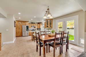 Dining space with recessed lighting and baseboards
