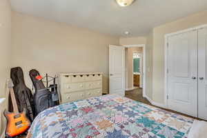 Bedroom with a closet, carpet flooring, and baseboards