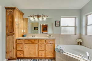Bathroom with a bath and vanity