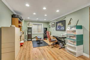 Office area featuring baseboards, crown molding, wood finished floors, and recessed lighting