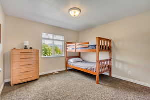 Carpeted bedroom with baseboards
