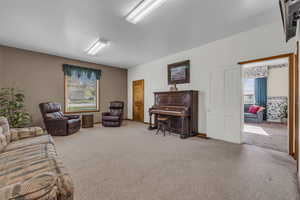 Living room with carpet floors. This room has been used as a master bedroom in past.