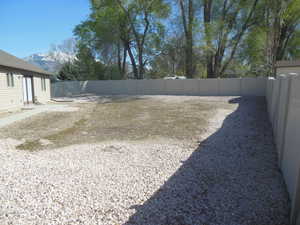 View of yard featuring a fenced backyard and a mountain view