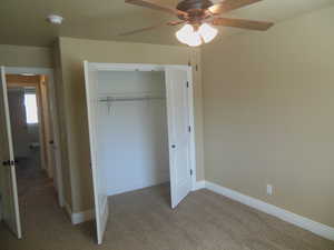 Rear bedroom with closet and ceiling fan.