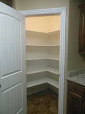 Corner walk-in pantry.