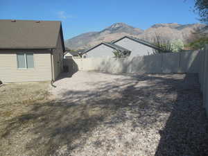 View of yard featuring a fenced backyard and a mountain view