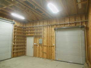 Interior of 20x20 garage showing 12 foot high ceiling and built-in shelving.