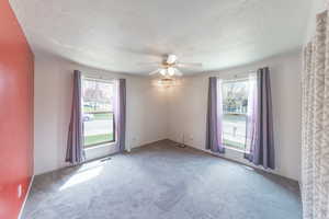 Bedroom 2 with ceiling fan and a wealth of natural light.