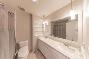 Main Bathroom featuring double sinks, updated vanity, tub & shower.