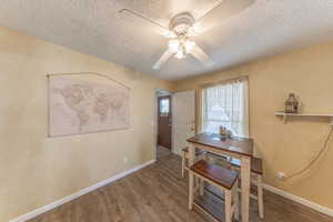 In kitchen semi-formal Dining space with wood finished floors, open window with view to the back yard.