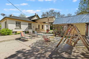 Rear view of property featuring an expansive patio area