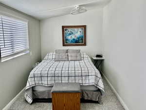 Carpeted bedroom with baseboards and a textured ceiling