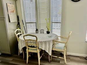 Dining area with baseboards, wood finished floors, and plenty of natural light